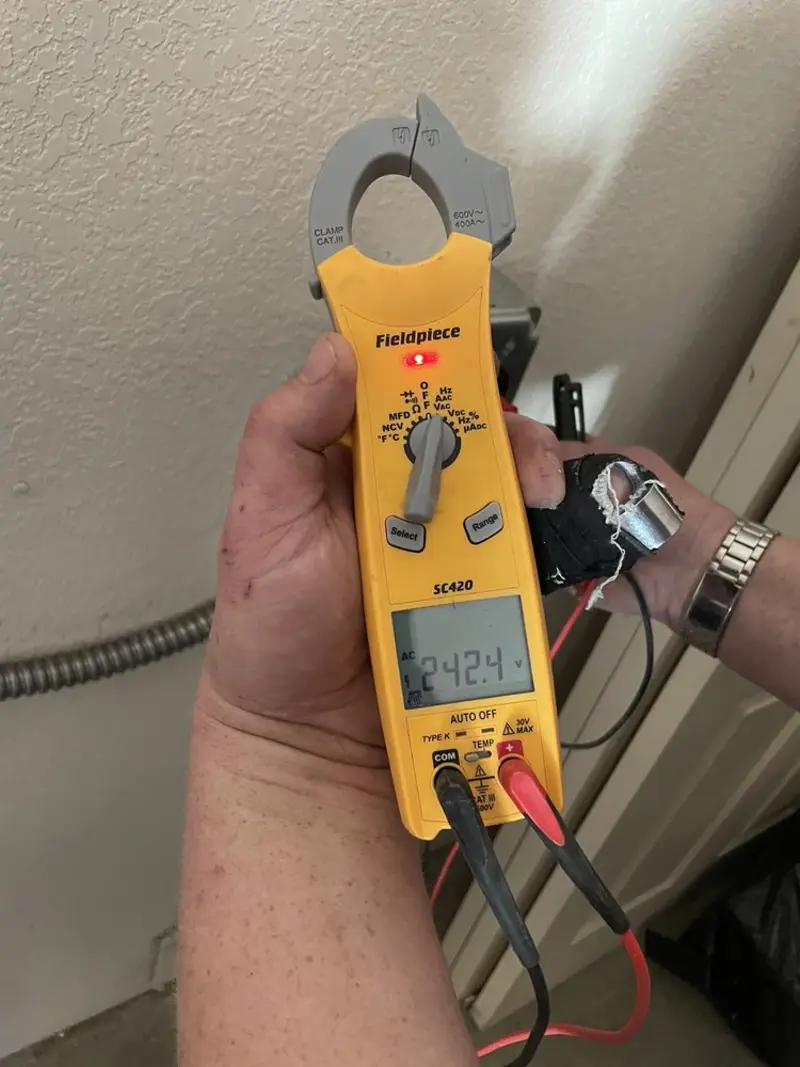 Voltage testing with clamp meter during Recessed Lighting Installation in Weiser